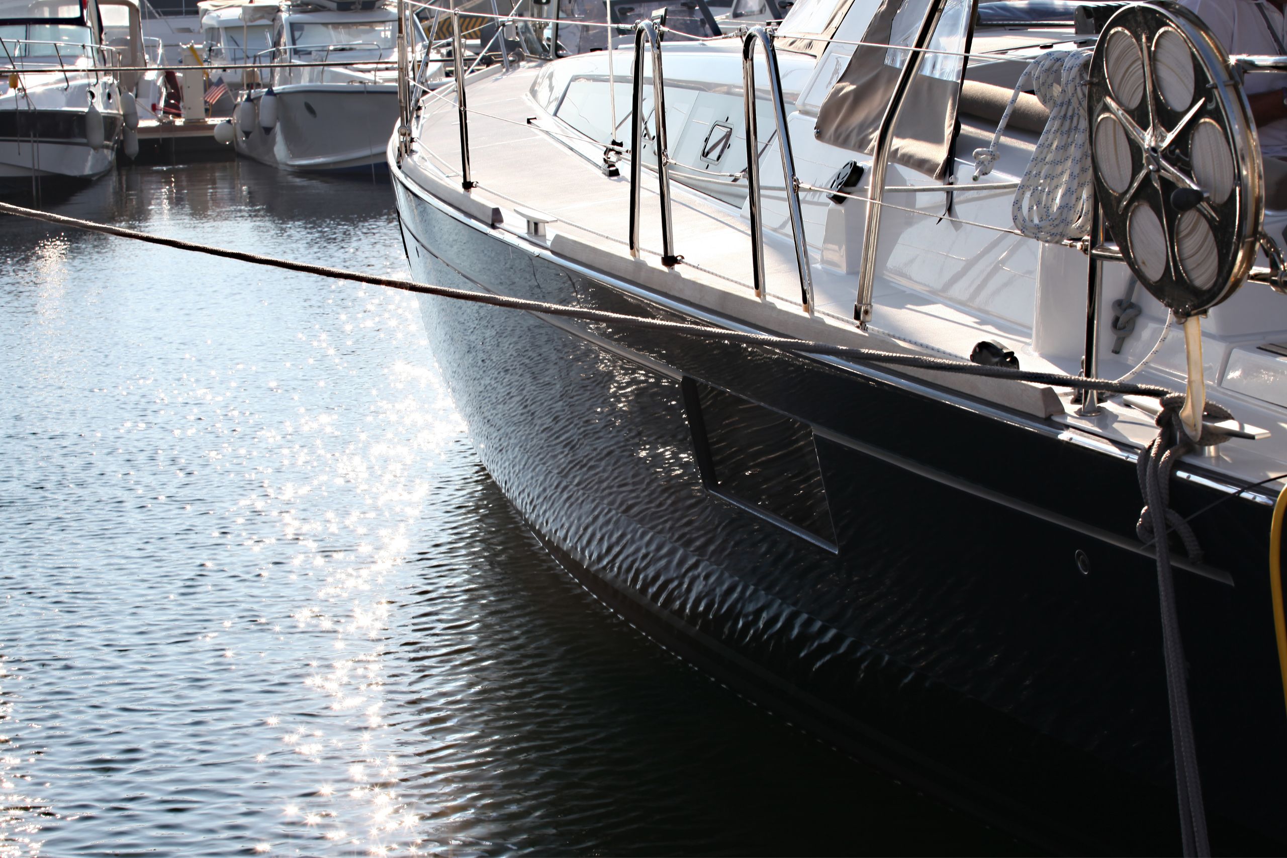 black boat exterior being maintained on the water